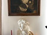 a statue of a woman on a table next to a lamp
