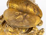 gold plated figurine of a man with a hat on his head
