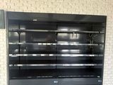 a large empty display case in the middle of a room