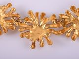 gold plated necklace with flowers and leaves on a white background