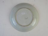 a white plate with a brown rim on a table