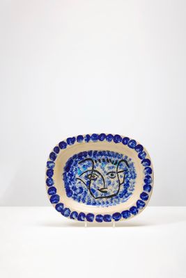 assiette en céramique bleue et blanche ornée d'un visage