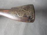 a small wooden object with a decorative design on it