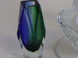 two glass vases sitting next to each other on a table