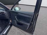 the interior of a car with the door open and the driver ' s seat down