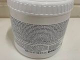 a close up of a jar of cream sitting on a counter