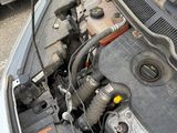 a car that has a broken engine and is parked on the side of the road