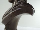 a bronze bust of a man with a hat on it