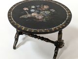 a black table with flowers on it on a white background