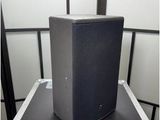 a black speaker sitting on top of a black case
