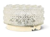 a clear glass candle holder with a wooden base