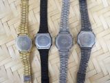 three watches sitting on top of a woven table next to each other