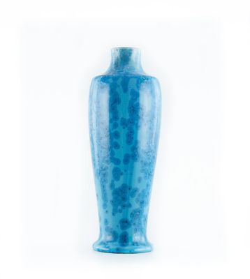 a blue vase that is sitting on a white surface