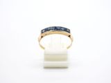 a close up of a gold ring with blue stones