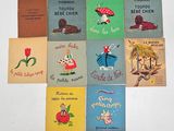 several children ' s books are arranged in a circle on a white surface
