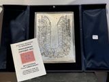 a picture of a silver plate in a black box