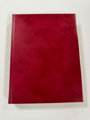 a red book sitting on top of a white table
