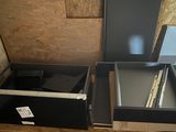 two open drawers in the corner of a room