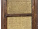 an old wooden window with a brown frame and wicker covering
