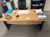 a desk with a chair and a computer on it
