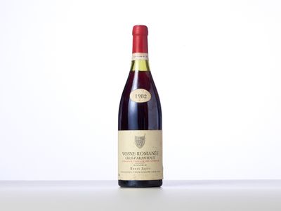 the bottle of wine is sitting on the table with a white background