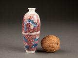 a picture of a small vase and walnuts on a table