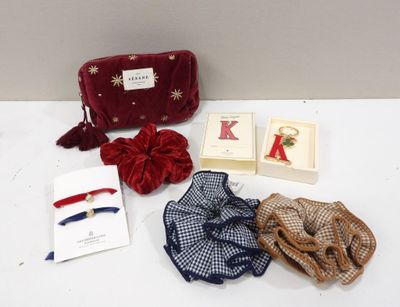 an assortment of items including a red purse, a red purse, a blue purse, and a red bow