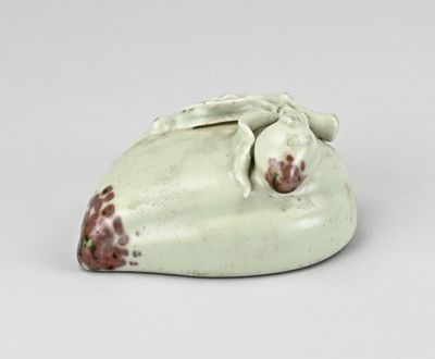 figurine en porcelaine représentant une girafe endormie sur un fond blanc