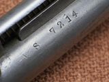 a close up of a gun on a brown surface