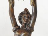 bronze statue of a woman holding a star above her head