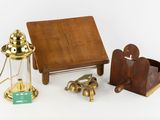 a small wooden table with a lamp and other items on it