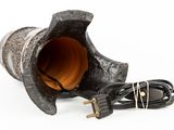 a black vase with a cord plugged into it