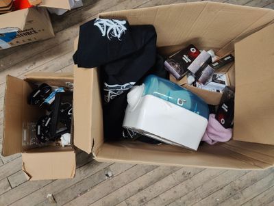 a cardboard box filled with assorted items on the floor