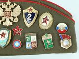 a lot of different badges on a green bag