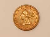 a close up of a gold coin with a woman ' s head on it