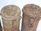 three old tins sitting next to each other on a table