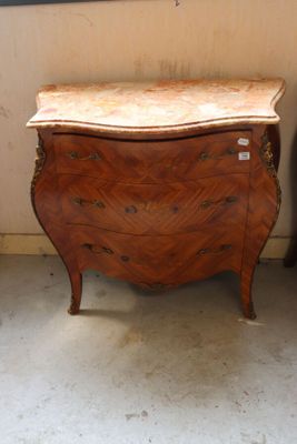 a small chest of drawers in the corner of a room