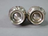 pair of silver plated salt and pepper shakers on a gray surface