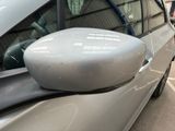 a side view mirror of a car on the side of the road