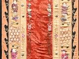 a picture of a red and beige rug on a wooden floor