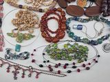 many different types of beaded necklaces and bracelets