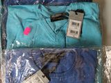 three pairs of t - shirts are wrapped in plastic bags