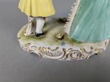 a figurine of a man and a woman holding hands