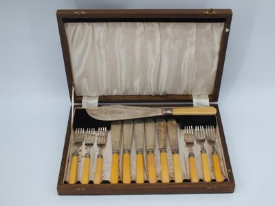 a wooden box with a set of knives and forks in it
