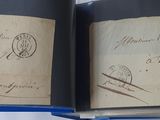an open book with stamps on it sitting on a table