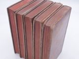 five books stacked on top of each other on a white surface