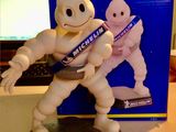 a toy figure of a man with a toothbrush in front of a box of toothpaste