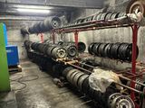 a room with a lot of tires and a rack with wheels
