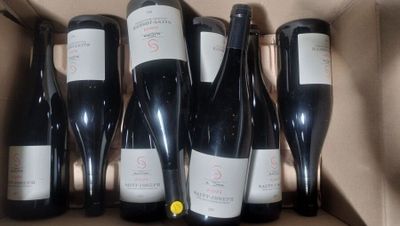 six bottles of wine in a box on the table