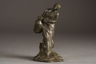 bronze statue of a woman holding a basket on a pedestal